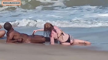 Interracial beach encounter with multiple partners and handjob action